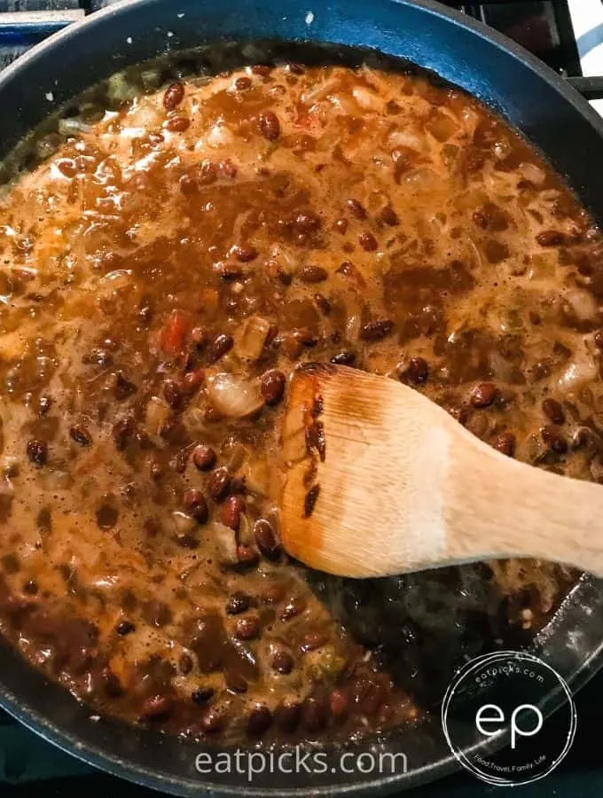 Black bean burrito mixture cooking in a frying pan