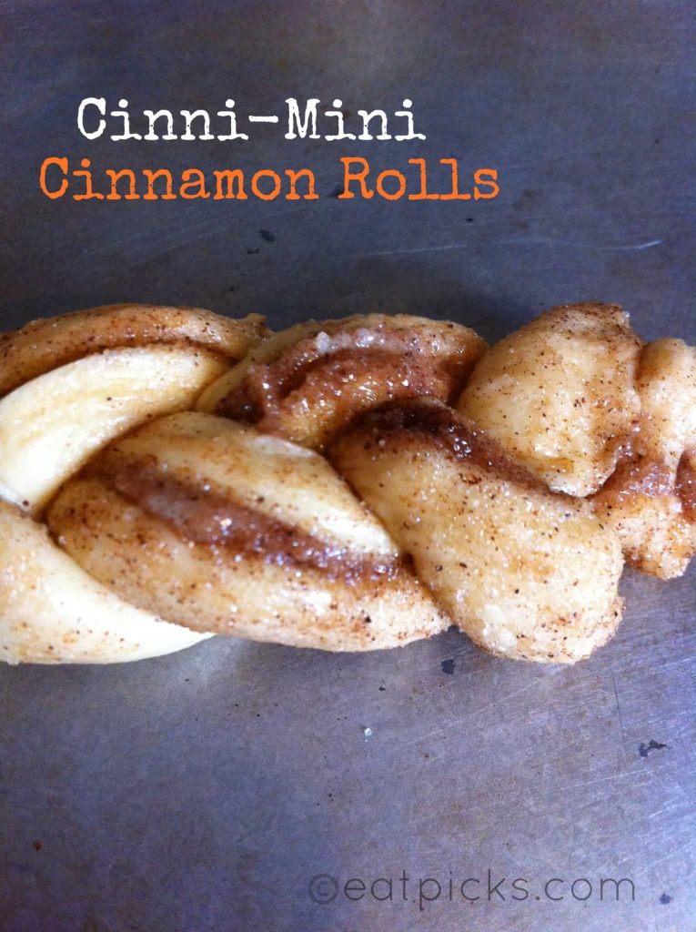 Mini cinnamon roll strips braided on a pan