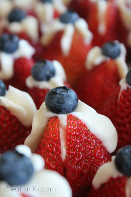 red white and blue stuffed strawberries with blueberry on top.
