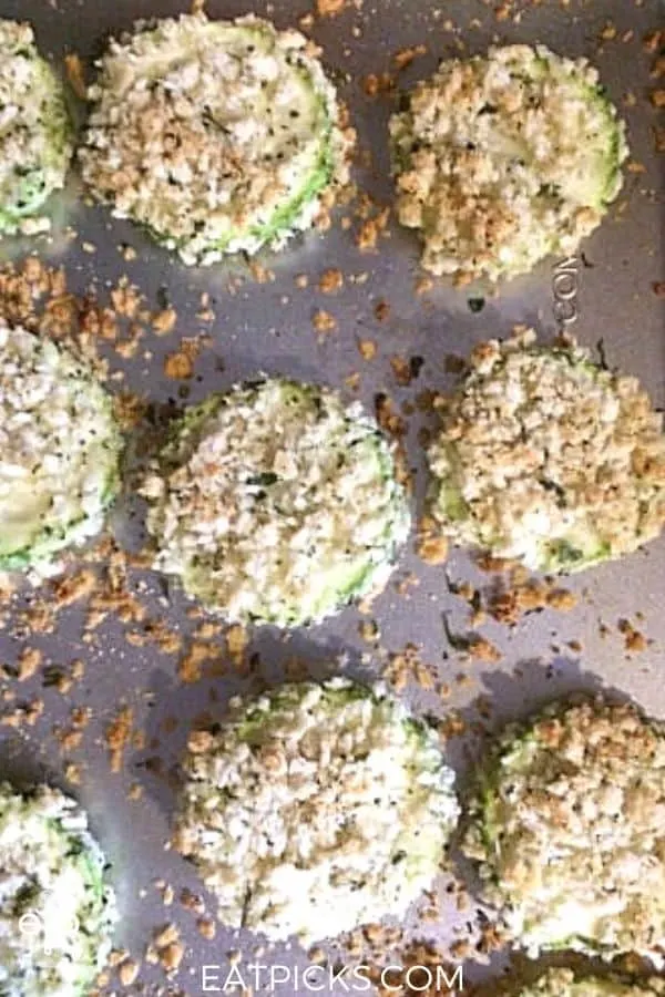 breaded zucchini slices on baking tray