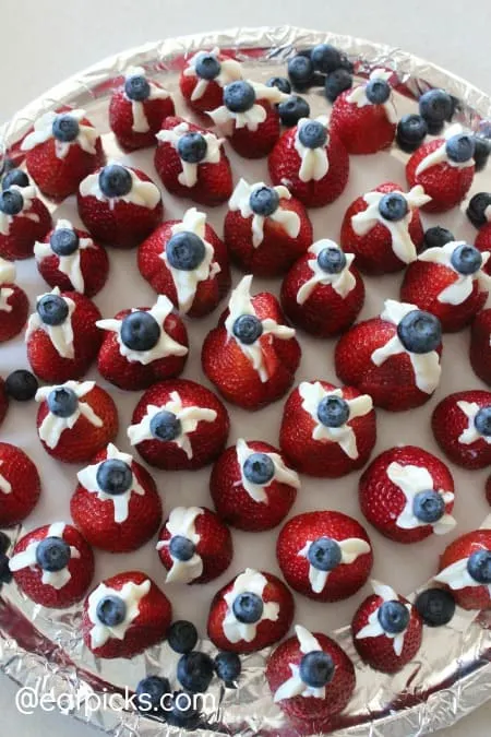 red white and blue stuffed strawberries on platter