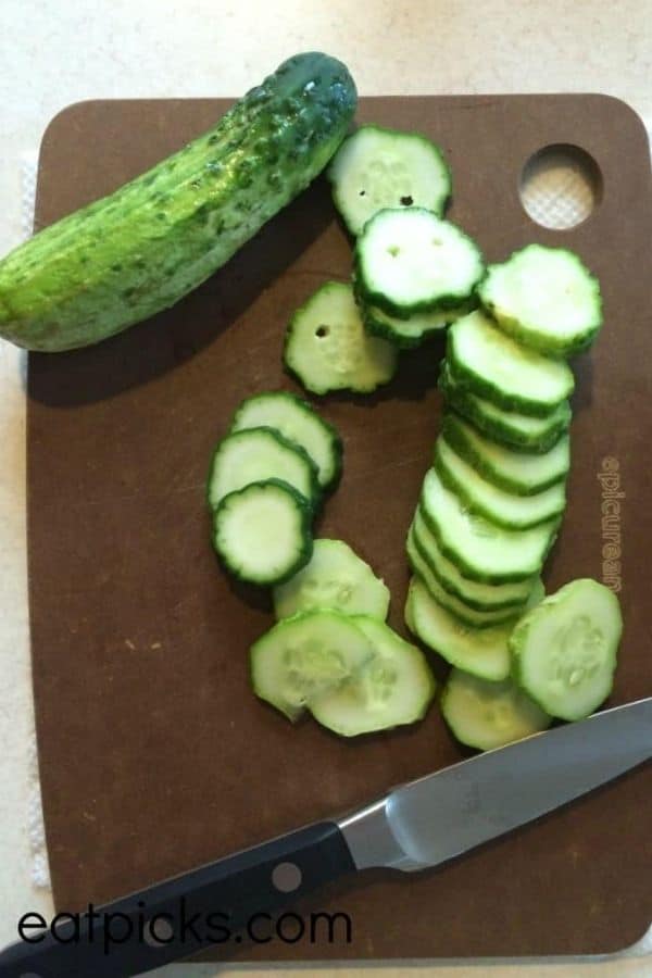 Sliced cucumbers on board for homemade pickles recipe