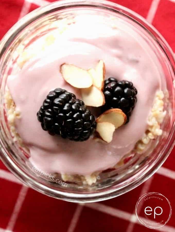 soy yogurt vegan parfait layered with steel cut oats topped with blackberries & almonds