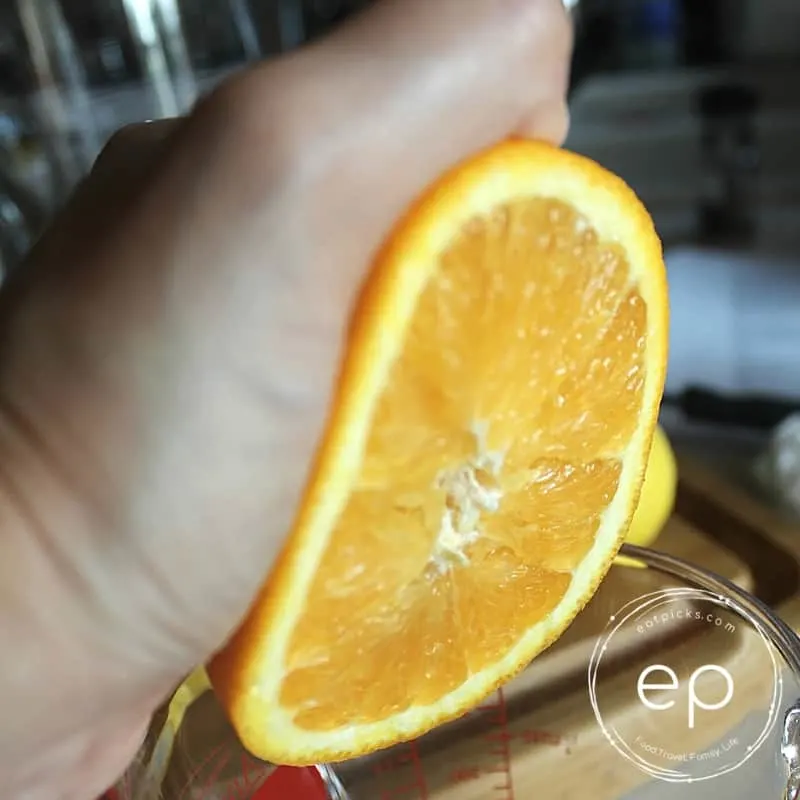 squeeze orange in a measuring cup