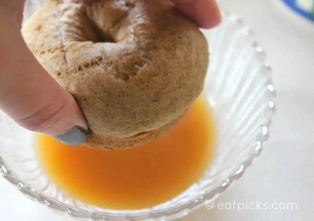 Dipping Apple donut in cider