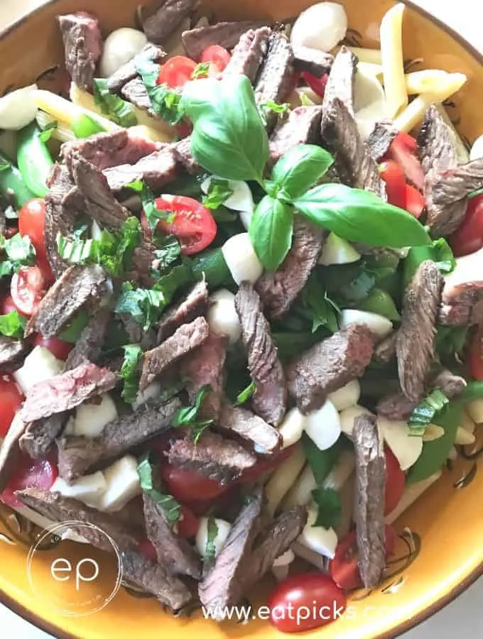 Sirloin steak and pasta salad with basil, mozzarella cheese, tomatoes and lemon vinaigrette