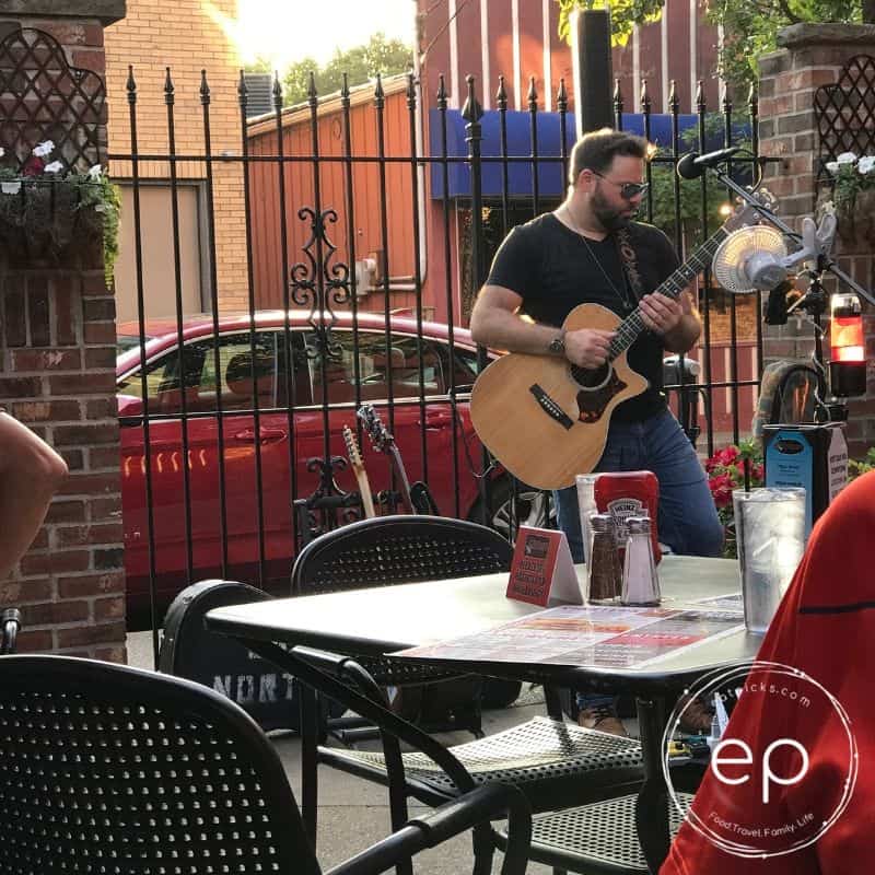 Man playing guitar in cafe