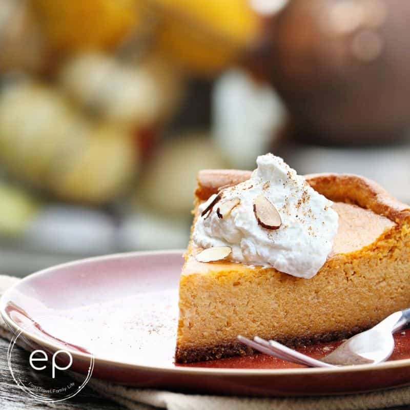 Slice of pumpkin pie with gingersnap crust and dollop of whipped cream