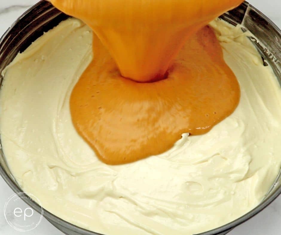pumpkin pie mixture pouring on top of cream cheese