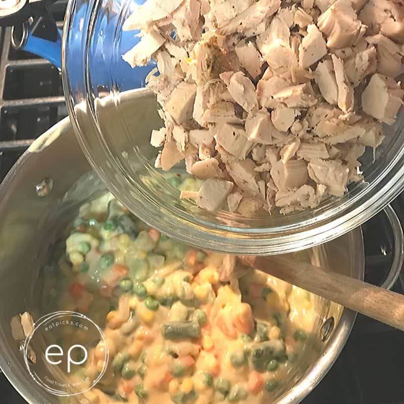 Adding Chopped turkey to pot pie filling mixture