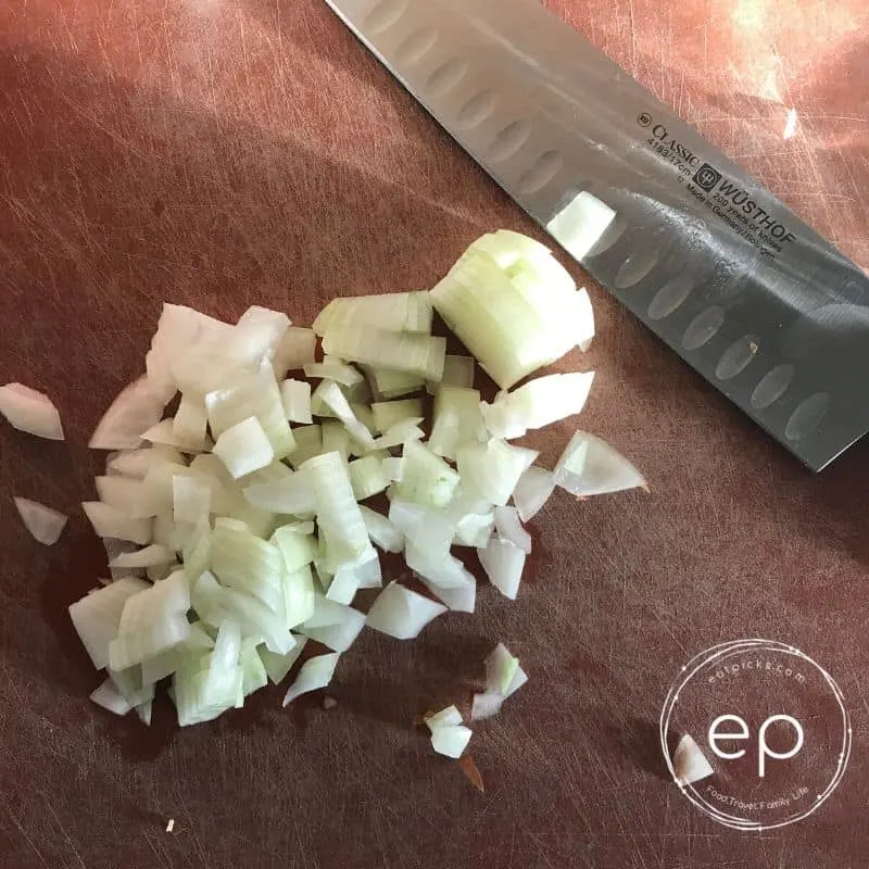 Chopped onions on cutting board for Chicken Pot Pie with Crescent Roll Crust