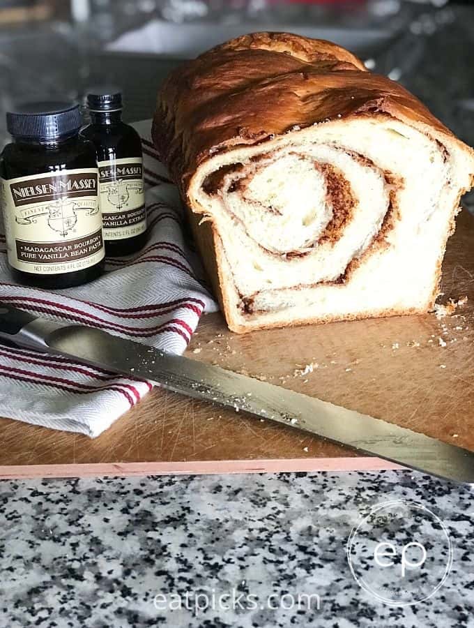 Cinnamon Swirl Bread on cutting board with vanilla