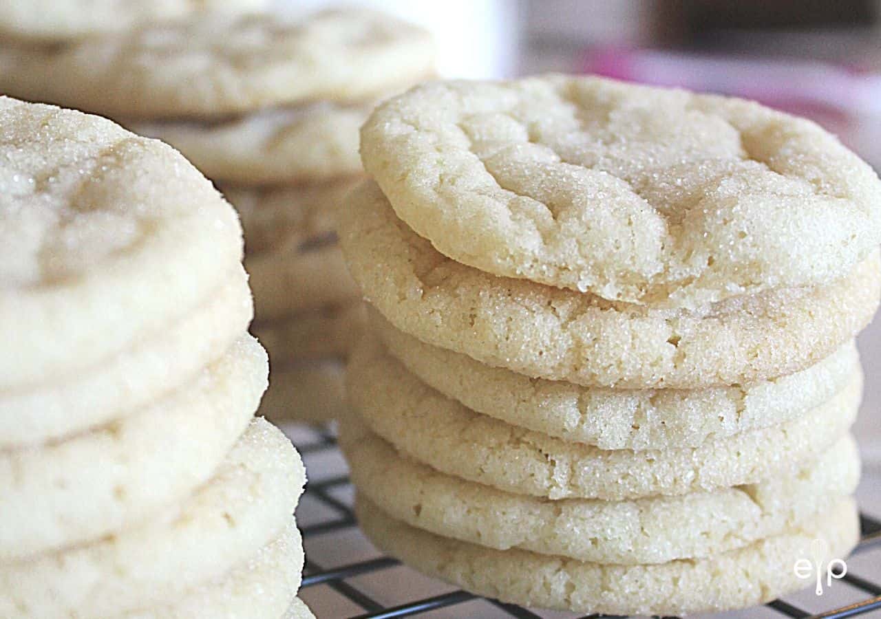 Sugar cookies stacked on cooling rack