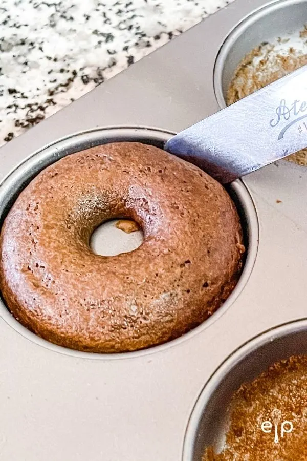 Removing baked donuts from pan to cool